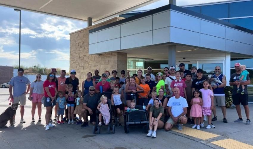 large group of people standing in front of hospital